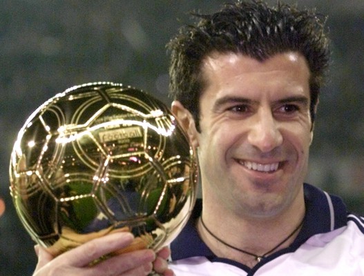 Real Madrid's Portuguese star Luis Figo poses for photographers as he holds the "Golden Ball" trophy..